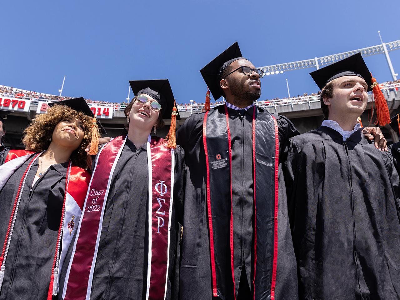 Graduates together at commencement